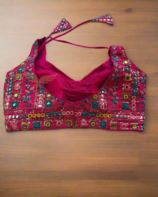 Decorative pink blouse with colorful embroidery on a pink fabric background